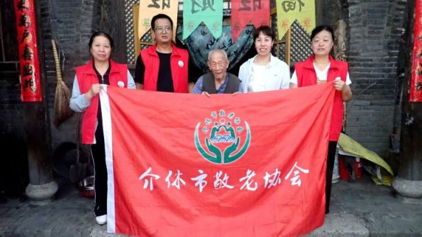 介休市敬老协会志愿者在介休市连福镇东杨屯村入户84岁特困老人李丰达家中为老人打扫室内外卫生