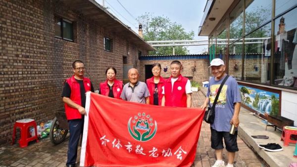 介休市敬老协会志愿者走进义安镇北辛武村90岁特困郭树信老人家为老人擦玻璃打扫室内外卫生包饺子