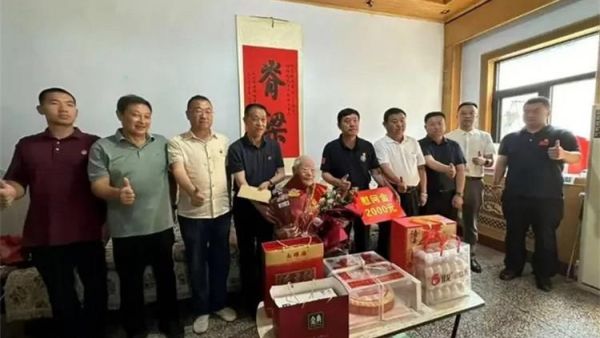 山西省爱国拥军促进会高温赴运城慰问95岁抗战老英雄郝洪文为老英雄献上两千元人民币慰问金及字画《脊梁》和纪念蛋糕